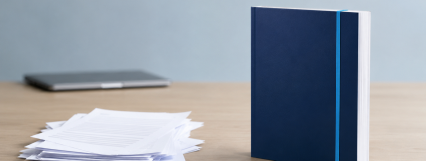 Quality Over Quantity in Blogging: Thin Drafts vs. Complete Content | Lucé Media Messy stack of thin blog drafts beside one complete bound document illustrating quality over quantity in blogging