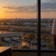 Who Owns Marketing: CEO at the Office Window | Lucé Media who owns marketing business owner standing at his office window looking out over his company and the market beyond